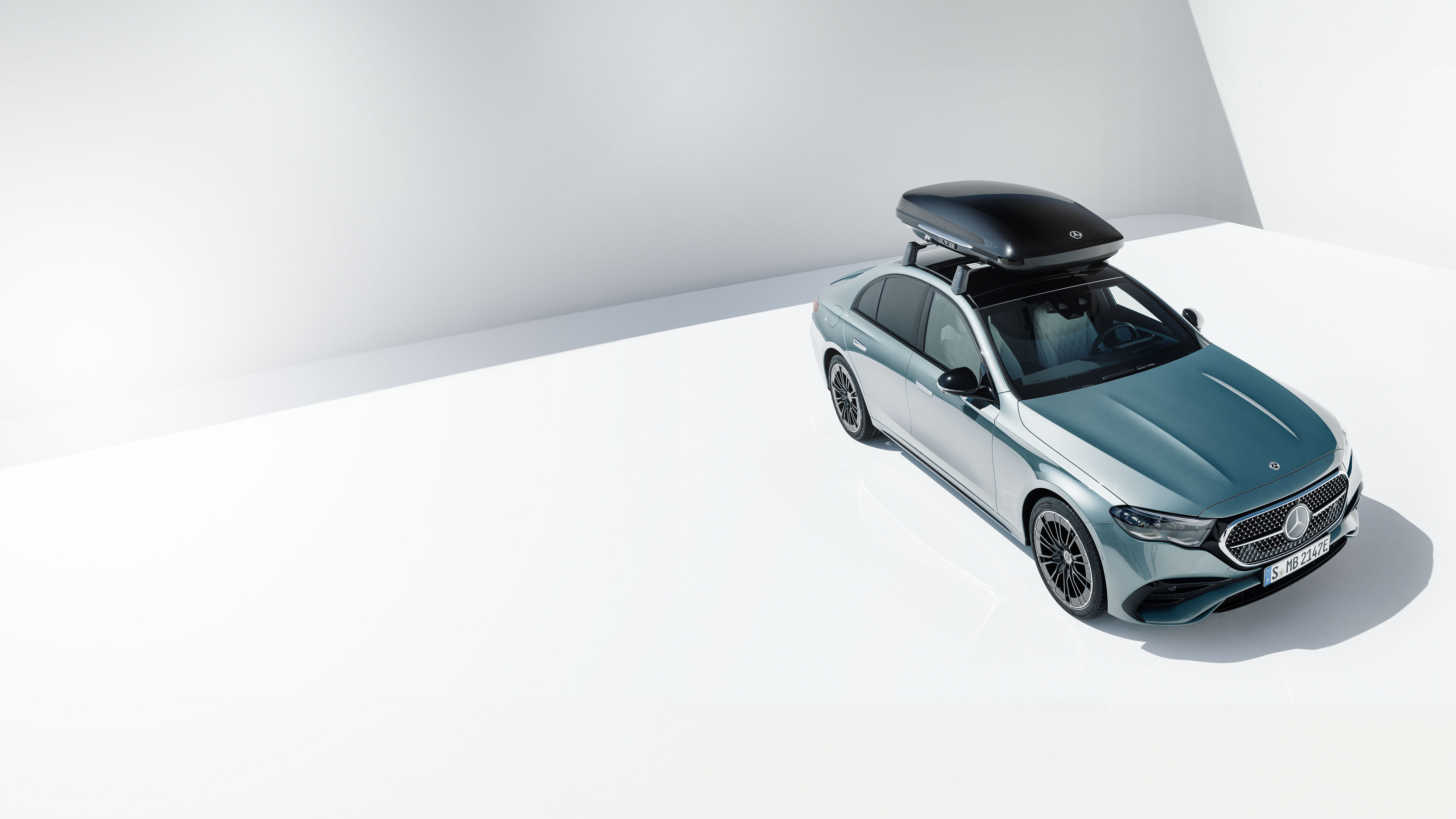 Mercedes-Benz Technical Accessories A silver Mercedes-Benz with carrier.