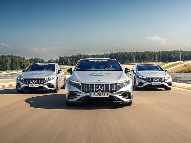Three vehicles on a race track.