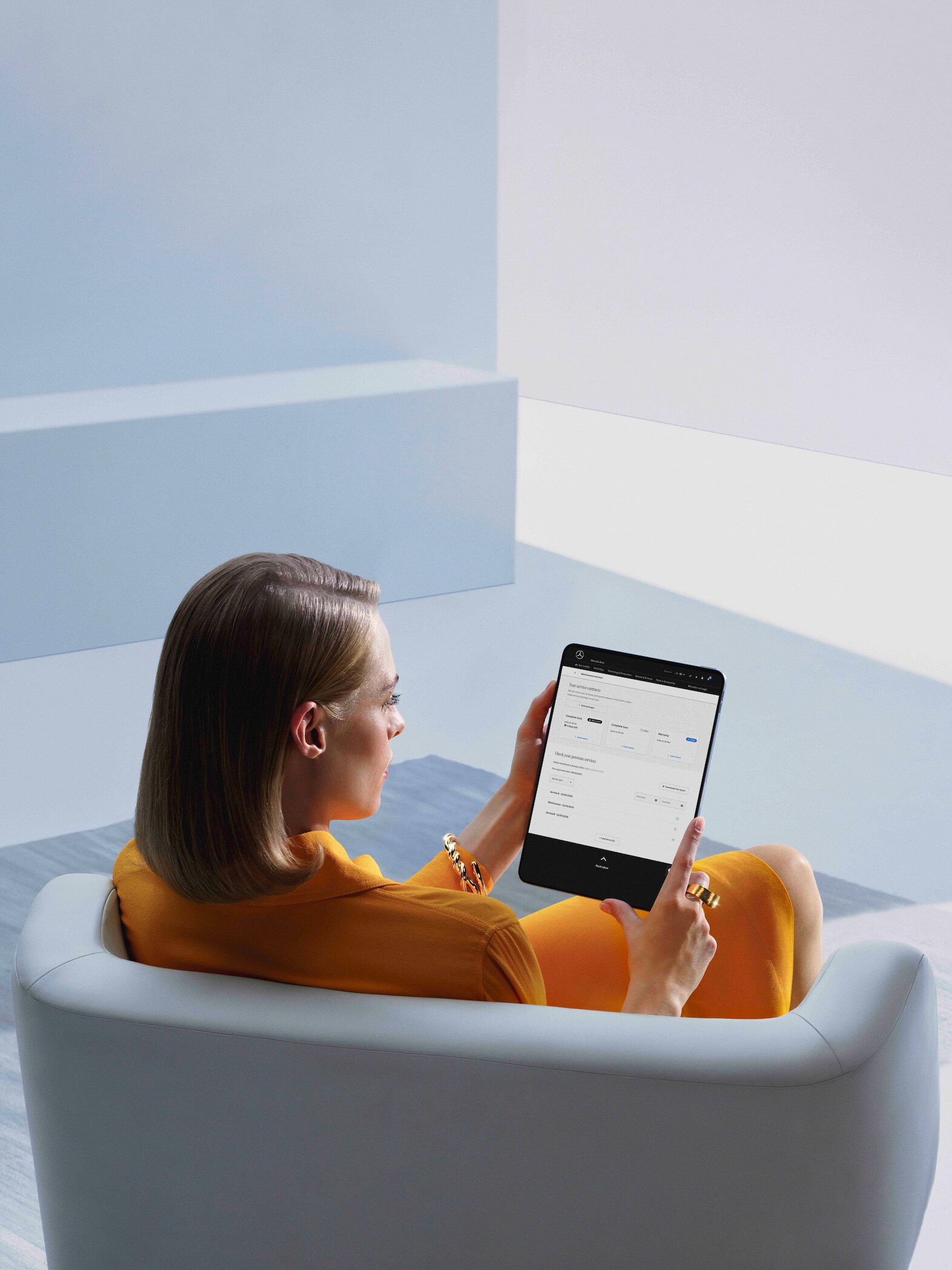 A woman is looking at her digital service report on her tablet.