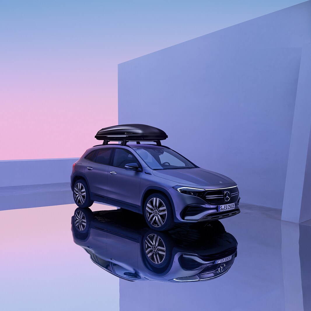 The Mercedes-Benz EQA is in a showroom with a roof luggage rack.