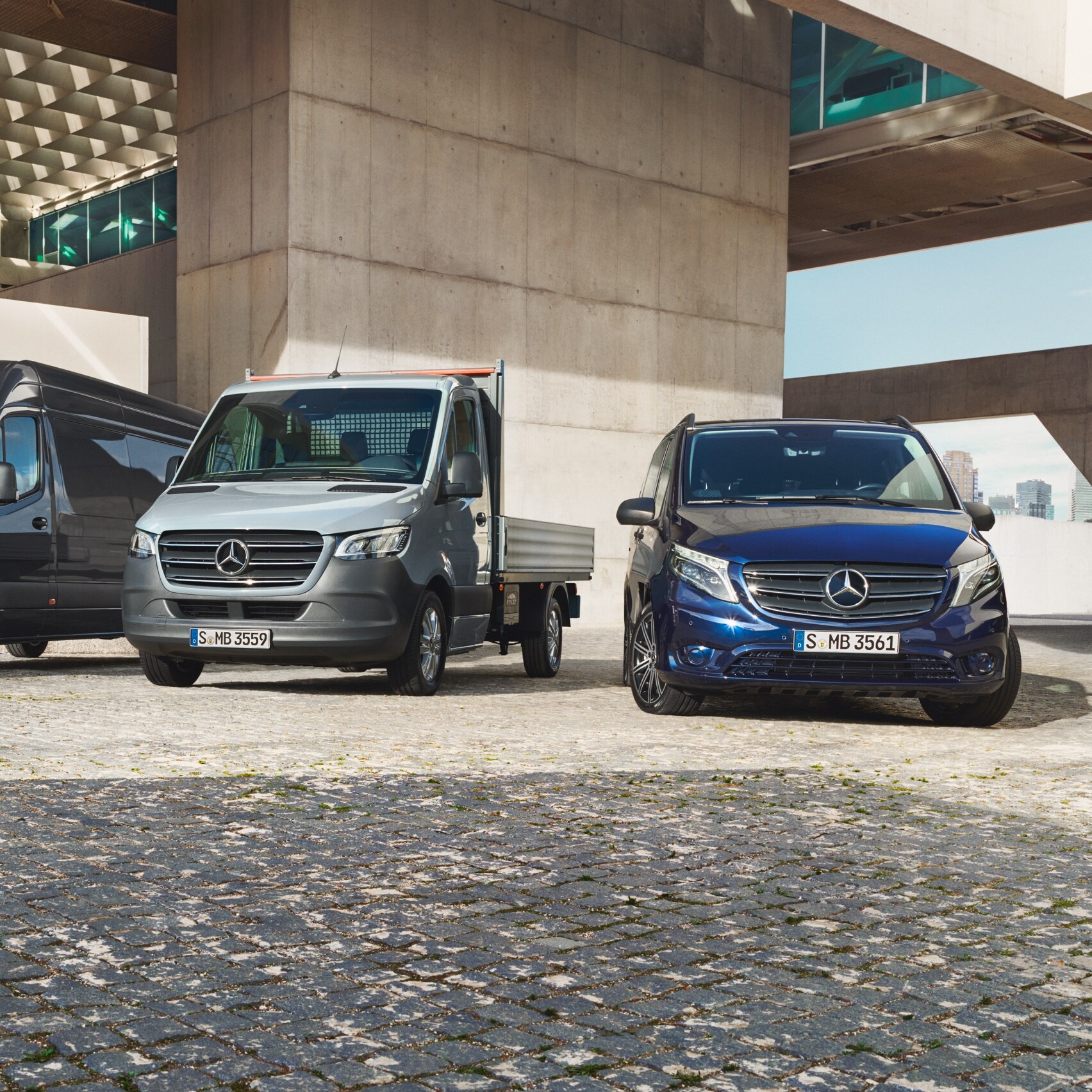 Mercedes-Benz Sprinter and Vito vans parked on a paved surface in industrial surroundings.