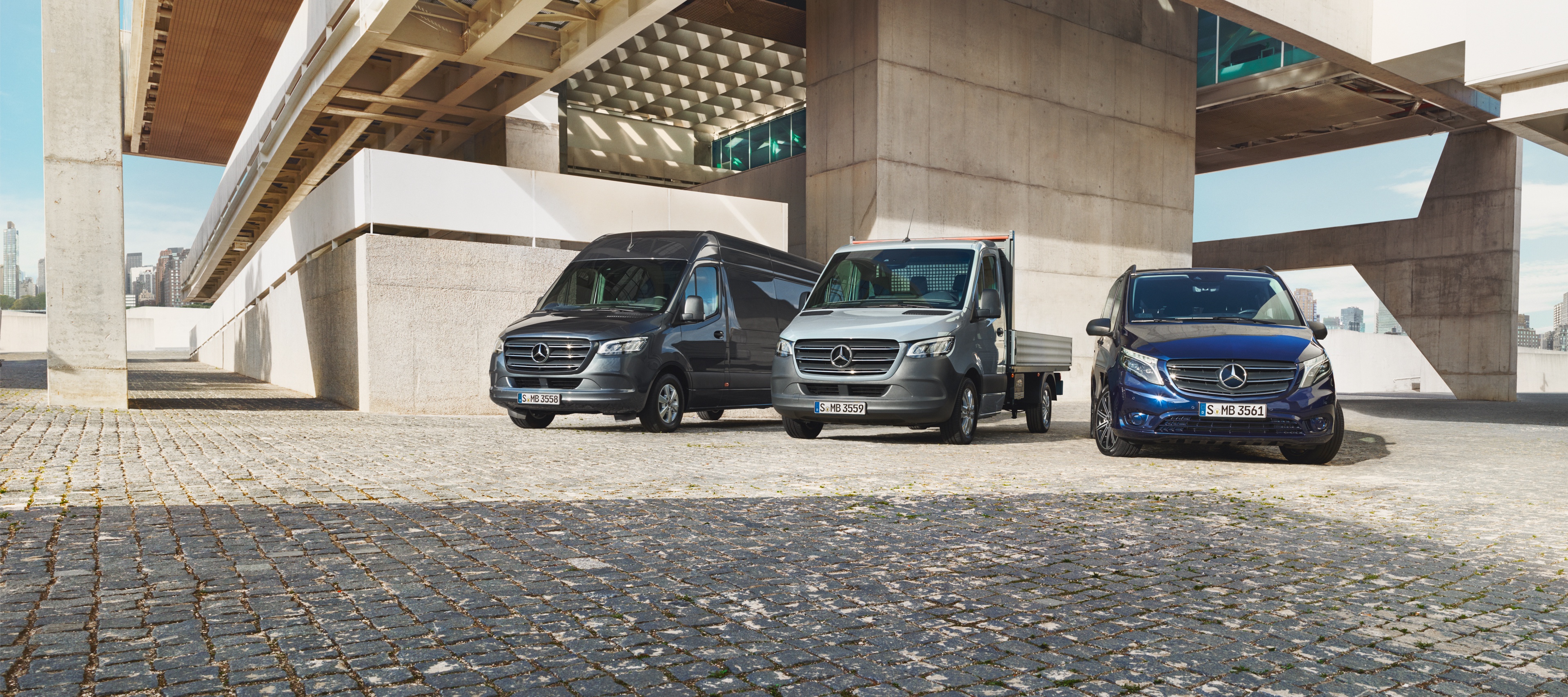 Mercedes-Benz Store | Mercedes-Benz Vans Mercedes-Benz Sprinter and Vito vans parked on a paved surface in industrial surroundings.
