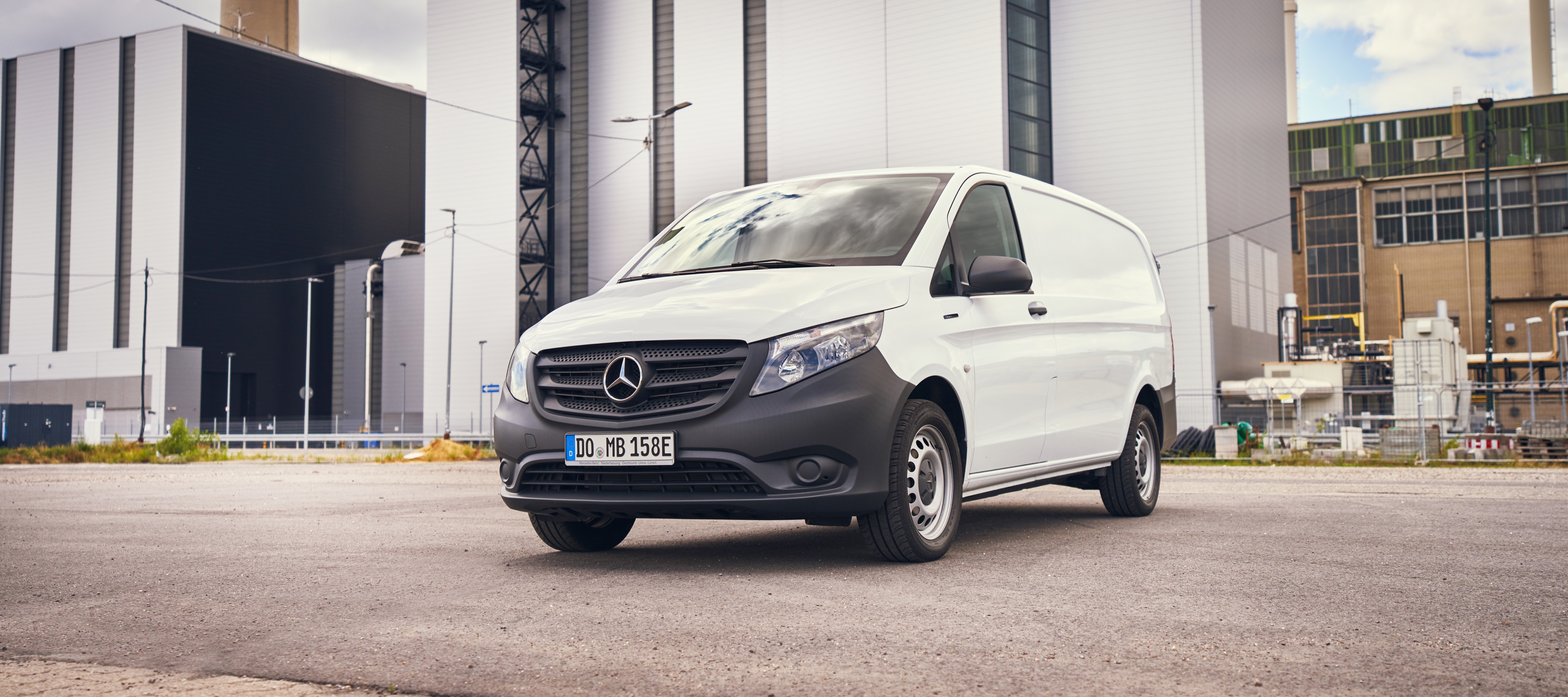 eVito panel van | Mercedes-Benz Vans A white eVito panel van from Mercedes-Benz parked on an industrial site.