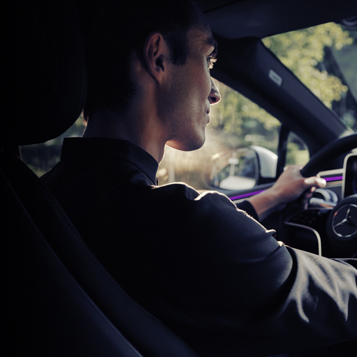 Man is driving Mercedes-Benz car